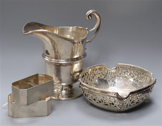 A pair of silver bon bon dishes, a pair of napkin rings and a cream jug.